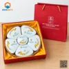 Khay đựng mứt sứ trắng họa tiết hoa mai vàng trong hộp quà đỏ
